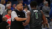 Feb 11, 2024; Memphis, Tennessee, USA; Tulane Green Wave head coach Ron Hunter (left) talks with Tulane Green Wave guard Sion James (1) during the first half against the Memphis Tigers at FedExForum. 