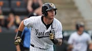 Vanderbilt infielder Braden Holcomb (26) runs to first base during a NCAA baseball game between the Tennessee Volunteers and Vanderbilt Commodores at Lindsey Nelson Stadium on May 11, 2025.