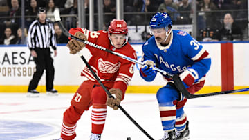 Nov 16, 2025; New York, New York, USA; Detroit Red Wings center Emmitt Finnie (58) and New York Rangers center Sam Carrick (39) compete for the puck during the second period at Madison Square Garden. Mandatory Credit: John Jones-Imagn Images