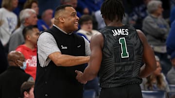 Feb 11, 2024; Memphis, Tennessee, USA; Tulane Green Wave head coach Ron Hunter (left) talks with Tulane Green Wave guard Sion James (1) during the first half against the Memphis Tigers at FedExForum.
