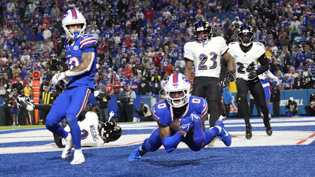 Baltimore Ravens cornerback Jaire Alexander (23) watches Buffalo Bills wide receiver Keon Coleman (0) score a touchdown.