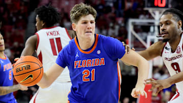 Jan 11, 2025; Fayetteville, Arkansas, USA; Florida Gators forward Alex Condon (21) drives against Arkansas Razorbacks forward Jonas Aidoo (9) in the second half at Bud Walton Arena. Florida won 71-63. Mandatory Credit: Nelson Chenault-Imagn Images