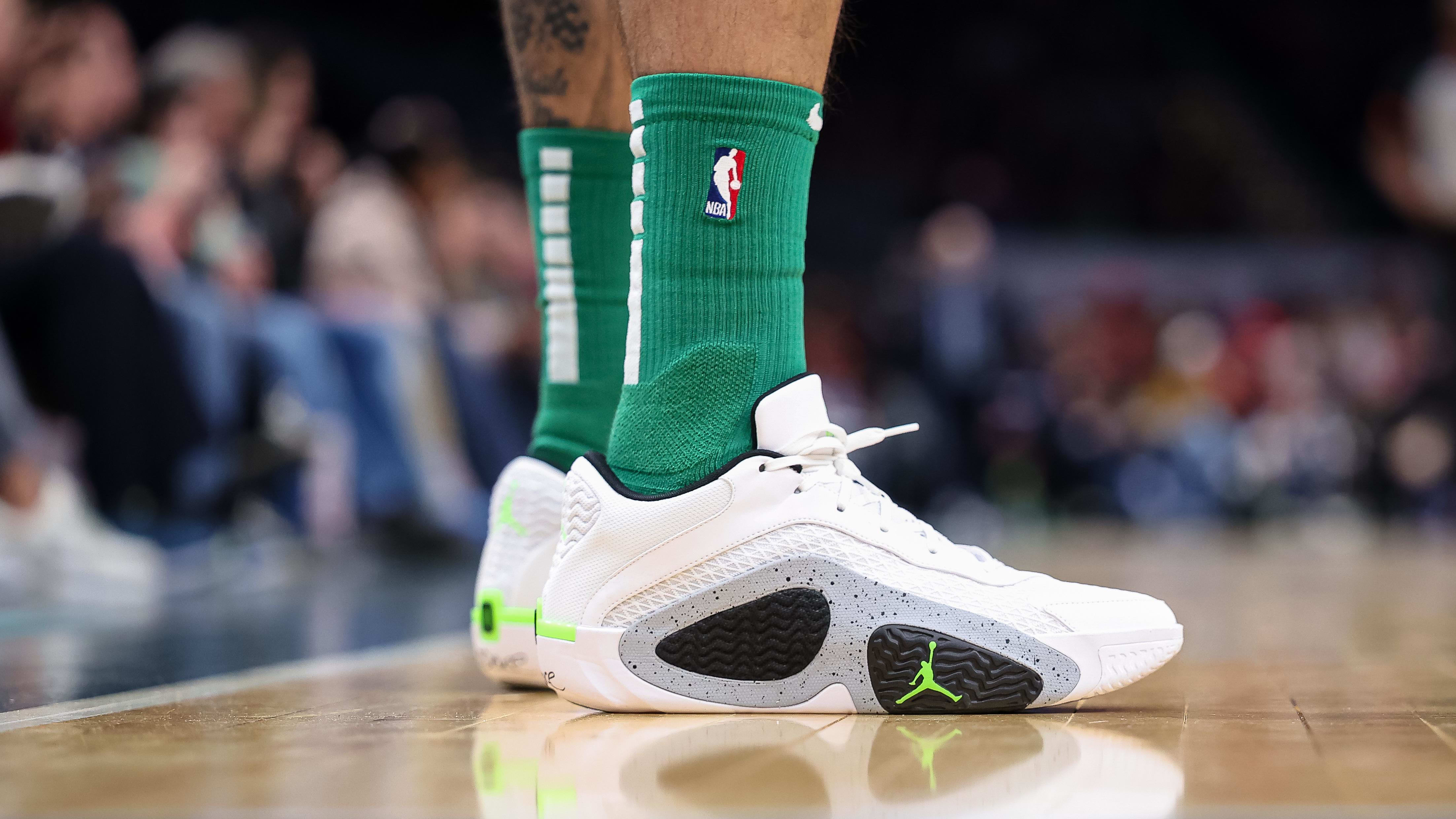 Boston Celtics forward Jayson Tatum's white and green sneakers.