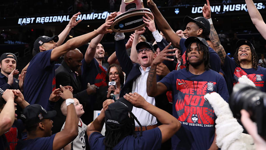 UConn coach Dan Hurley and the Huskies players celebrate after winning the East Regional final over Duke.