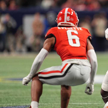 Dec 7, 2024; Atlanta, GA, USA; Texas Longhorns running back Quintrevion Wisner (26) rushes the ball against Georgia Bulldogs defensive back Daylen Everette (6) during the first half in the 2024 SEC Championship game at Mercedes-Benz Stadium. Mandatory Credit: Dale Zanine-Imagn Images