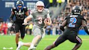 Sep 13, 2024; Kansas City, Kansas, USA; UNLV Rebels quarterback Matthew Sluka (3) runs the ball against Kansas Jayhawks defensive end Dean Miller (45) and cornerback Cobee Bryant (2) during the first half at Children's Mercy Park. Mandatory Credit: Jay Biggerstaff-Imagn Images