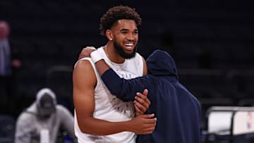 Oct 13, 2024; New York, New York, USA; Minnesota Timberwolves guard Mike Conley (10), right, embraces New York Knicks center Karl-Anthony Towns (32), left, before the game at Madison Square Garden. 