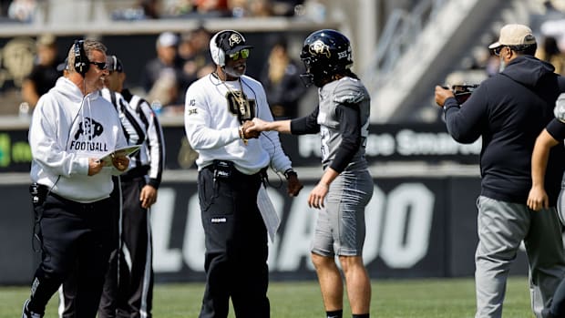 Apr 19, 2025; Boulder, CO, USA; Colorado Buffaloes head coach Deion Sanders and place kicker Buck Buchanan (43) during the sp