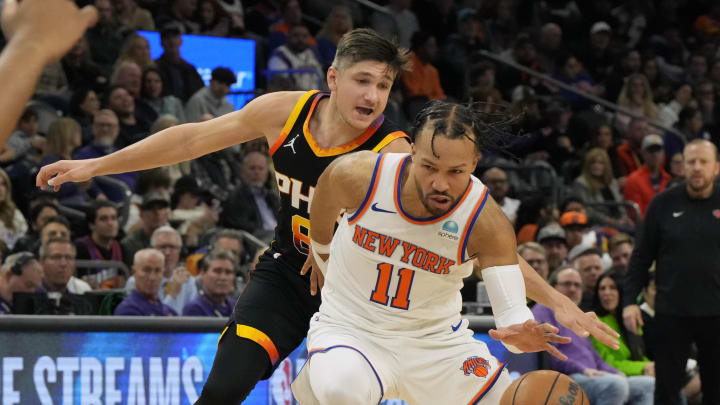 Dec 15, 2023; Phoenix, Arizona, USA; New York Knicks guard Jalen Brunson (11) drives on Phoenix Suns guard Grayson Allen (8) in the second half at Footprint Center. Mandatory Credit: Rick Scuteri-USA TODAY Sports