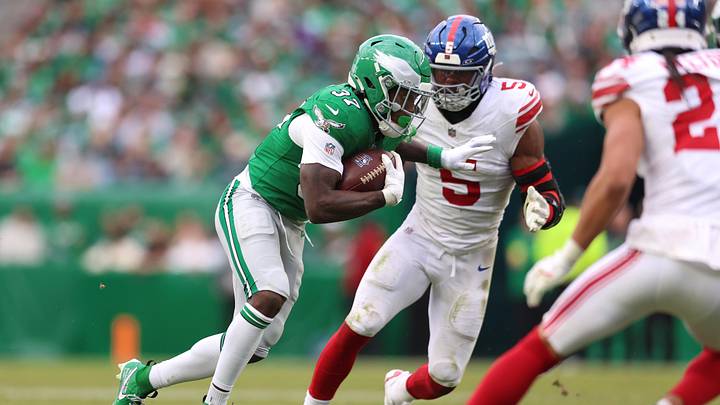 Oct 26, 2025; Philadelphia, Pennsylvania, USA; Philadelphia Eagles running back Tank Bigsby (37) runs against New York Giants linebacker Kayvon Thibodeaux (5) in the fourth quarter at Lincoln Financial Field. Mandatory Credit: Bill Streicher-Imagn Images