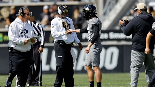 Colorado Buffaloes head coach Deion Sanders and place kicker Buck Buchanan (43) during the spring game at Folsom Field.