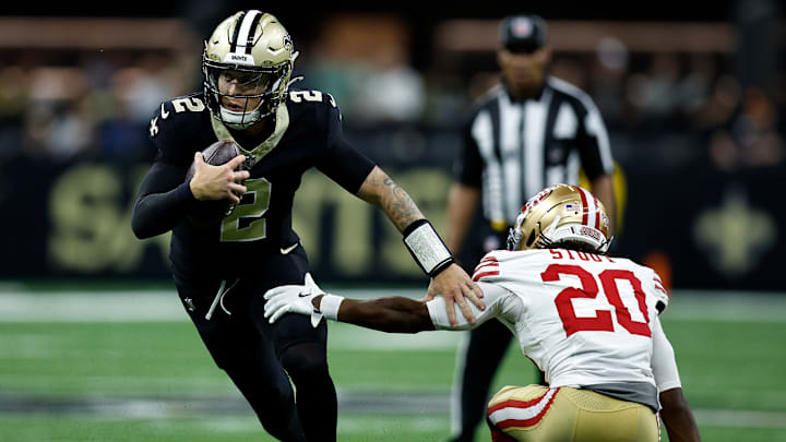 New Orleans Saints QB Spencer Rattler (2) scrambles past San Francisco 49ers CB Upton Stout (20) in an early afternoon matchup on Sep. 14, 2025.