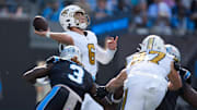 Nov 9, 2025; Charlotte, North Carolina, USA;  New Orleans Saints quarterback Tyler Shough (6) throws a pass as Carolina Panthers linebacker Princely Umanmielen (3) defends during the second quarter at Bank of America Stadium. Mandatory Credit: Jim Dedmon-Imagn Images