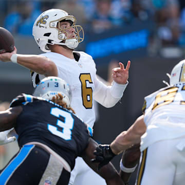 Nov 9, 2025; Charlotte, North Carolina, USA;  New Orleans Saints quarterback Tyler Shough (6) throws a pass as Carolina Panthers linebacker Princely Umanmielen (3) defends during the second quarter at Bank of America Stadium. Mandatory Credit: Jim Dedmon-Imagn Images