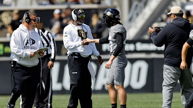 Apr 19, 2025; Boulder, CO, USA; Colorado Buffaloes head coach Deion Sanders and place kicker Buck Buchanan (43) during the sp