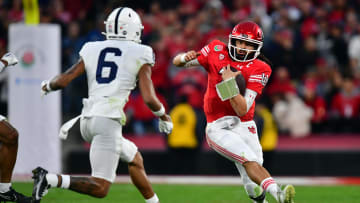Utah Utes quarterback Cameron Rising (7) runs against Penn State Nittany Lions safety Zakee Wheatley (6) 
