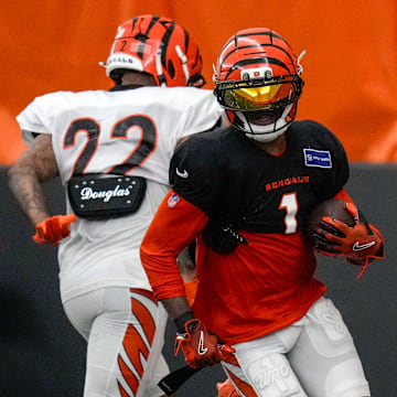 Cincinnati Bengals wide receiver Ja'Marr Chase (1) runs with a catch during a preseason training camp practice in downtown Cincinnati on Thursday, July 31, 2025.