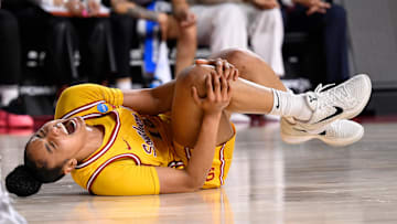 Mar 24, 2025; Los Angeles, California, USA; USC Trojans guard JuJu Watkins (12) grabs her knee after falling g to the floor during the first quarter of an NCAA Tournament second round game against the Mississippi State Bulldogs at Galen Center. Mandatory Credit: Robert Hanashiro-Imagn Images