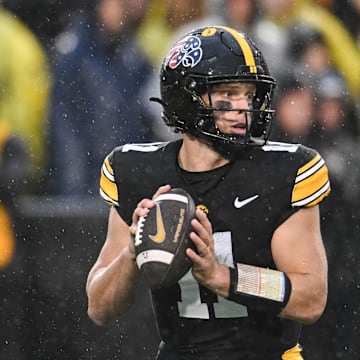 Nov 8, 2025; Iowa City, Iowa, USA; Iowa Hawkeyes quarterback Mark Gronowski (11) prepares to throw a pass against the Oregon Ducks during the first quarter at Kinnick Stadium. Mandatory Credit: Jeffrey Becker-Imagn Images
