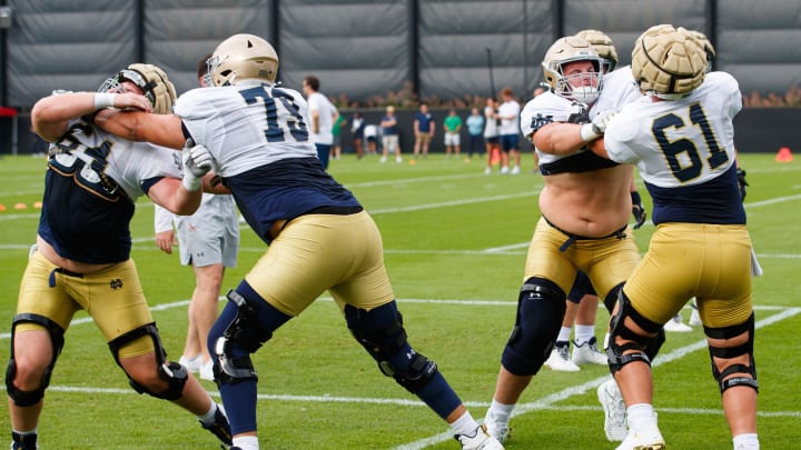 Notre Dame offensive linemen Peter Jones (73) and Robbie Wollan (61) participate in a drill during a Notre Dame football practice at Irish Athletic Center on Tuesday, Aug. 6, 2024, in South Bend.