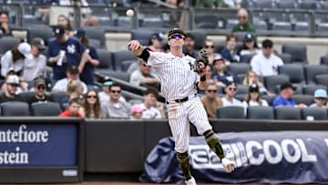 May 19, 2024; Bronx, New York, USA; New York Yankees third baseman Jon Berti (19) fields a ground ball and throws to first base for an out during the eighth inning against the Chicago White Sox at Yankee Stadium. Mandatory Credit: John Jones-Imagn Images