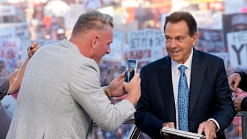 Oct. 4, 2025; Tuscaloosa, Alabama, USA; Pat McAfee takes a cell phone video of former Alabama head coach Nick Saban, now a co-host of the ESPN College GameDay show, as he comes on set on location on the Quad at the University of Alabama before the Alabama versus Vanderbilt game.