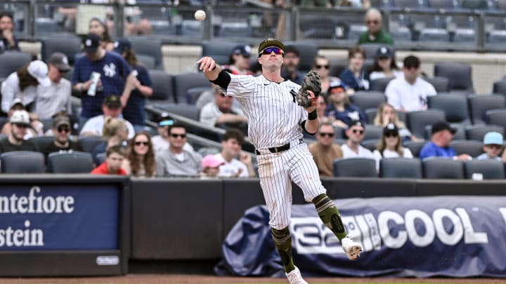 May 19, 2024; Bronx, New York, USA; New York Yankees third baseman Jon Berti (19) fields a ground ball and throws to first base for an out during the eighth inning against the Chicago White Sox at Yankee Stadium. Mandatory Credit: John Jones-USA TODAY Sports