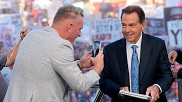 Oct. 4, 2025; Tuscaloosa, Alabama, USA; Pat McAfee takes a cell phone video of former Alabama head coach Nick Saban, now a co-host of the ESPN College GameDay show, as he comes on set on location on the Quad at the University of Alabama before the Alabama versus Vanderbilt game.