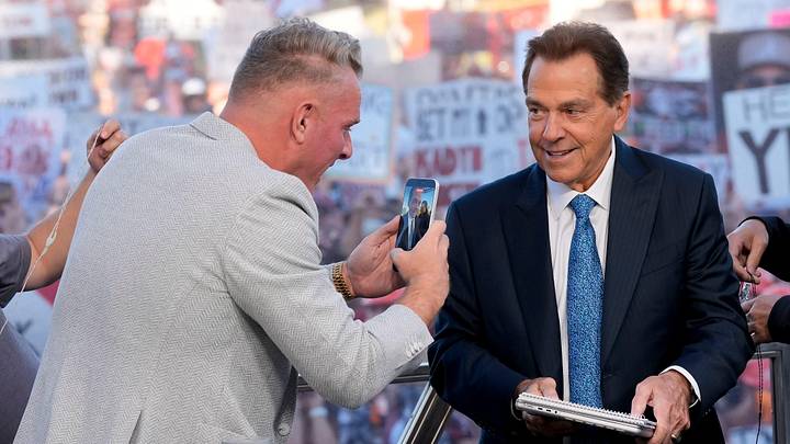 Oct. 4, 2025; Tuscaloosa, Alabama, USA; Pat McAfee takes a cell phone video of former Alabama head coach Nick Saban, now a co-host of the ESPN College GameDay show, as he comes on set on location on the Quad at the University of Alabama before the Alabama versus Vanderbilt game.