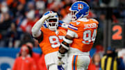 Jan 5, 2025; Denver, Colorado, USA; Denver Broncos defensive tackle Malcolm Roach (97) celebrates the sack of defensive tackle Jordan Jackson (94) in the fourth quarter against the Kansas City Chiefs at Empower Field at Mile High. 