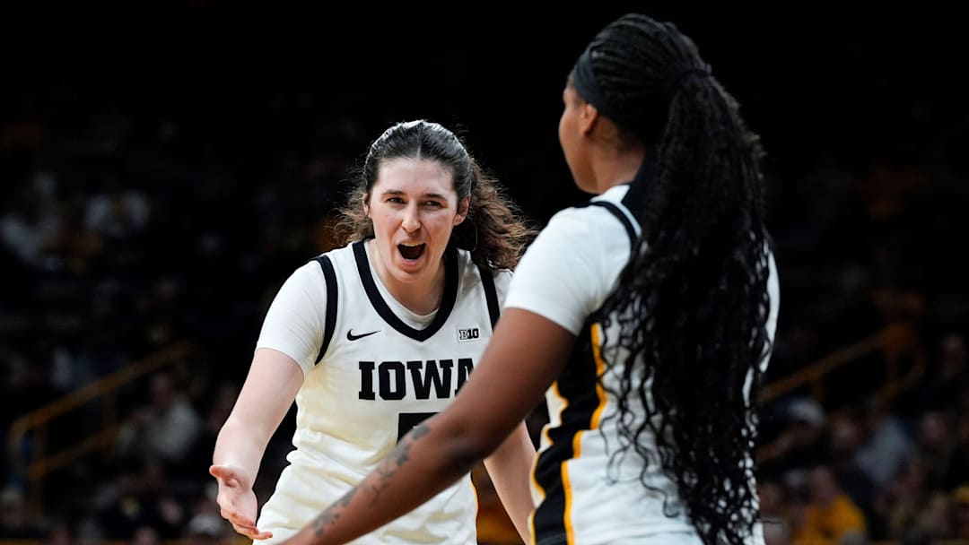 Iowa center Ava Heiden (5) high-fives Iowa guard Journey Houston (8) during a basketball game against the Western Illinois Leathernecks Nov. 26, 2025 at Carver-Hawkeye Arena in Iowa City, Iowa.