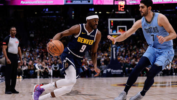 Mar 25, 2024; Denver, Colorado, USA; Denver Nuggets forward Justin Holiday (9) controls the ball as Memphis Grizzlies forward Santi Aldama (7) guards in the third quarter at Ball Arena. Mandatory Credit: Isaiah J. Downing-USA TODAY Sports