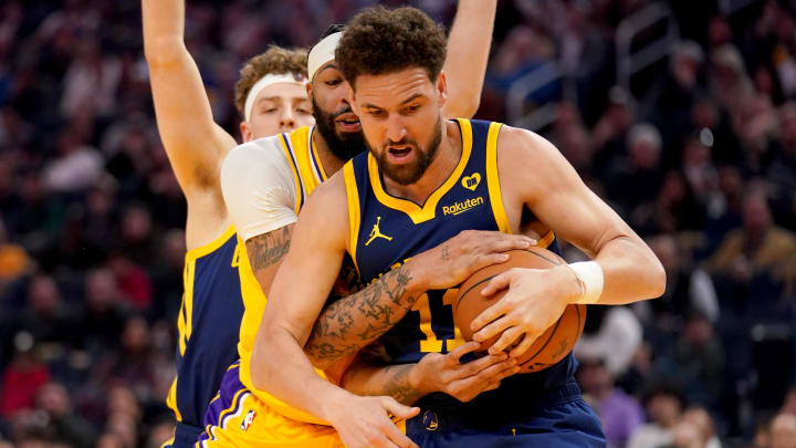 Feb 22, 2024; San Francisco, California, USA; Golden State Warriors guard Klay Thompson (11) takes the ball away from Los Angeles Lakers forward Anthony Davis (3) in the first quarter at the Chase Center. Mandatory Credit: Cary Edmondson-USA TODAY Sports