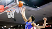 Kansas guard Kevin McCullar Jr. (15) lays up the ball past Oklahoma forward Sam Godwin (10) in the first half during an NCAA basketball game between The University of Oklahoma (OU) and The University of Kansas (KU), at the Lloyd Noble Center in Norman Okla., on Saturday, Feb. 17, 2024.