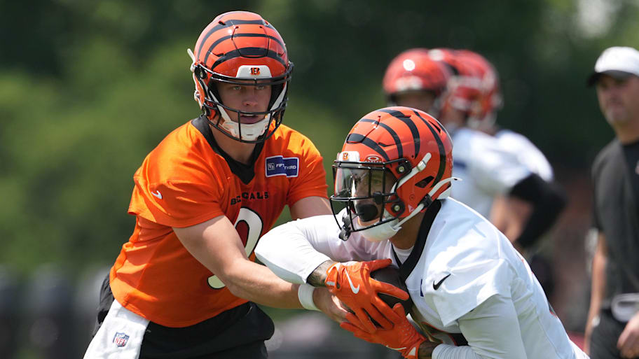 Jun 10, 2025; Cincinnati, OH, USA; Cincinnati Bengals running back Chase Brown (30) takes a carry from quarterback Joe Burrow (9) during practice at Paycor Stadium. Mandatory Credit: Kareem Elgazzar-Imagn Images | Kareem Elgazzar-Imagn Images