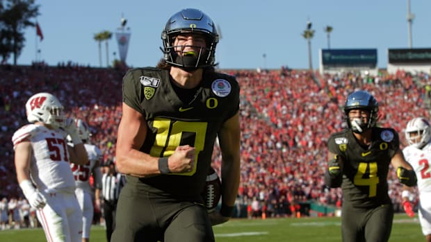 Oregon's Justin Herbert celebrates a first quarter touchdown against Wisconsin in the Rose Bowl in Pasadena on New Years Day