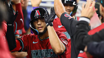 Aug 19, 2024; Miami, Florida, USA; Arizona Diamondbacks catcher Adrian Del Castillo (25) celebrates with teammates after hitting a grand slam against the Miami Marlins during the third inning at loanDepot Park. Mandatory Credit: Sam Navarro-Imagn Images