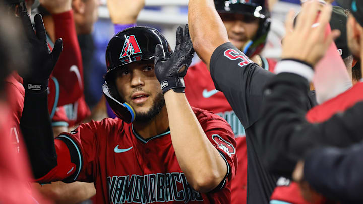 Aug 19, 2024; Miami, Florida, USA; Arizona Diamondbacks catcher Adrian Del Castillo (25) celebrates with teammates after hitting a grand slam against the Miami Marlins during the third inning at loanDepot Park. Mandatory Credit: Sam Navarro-Imagn Images