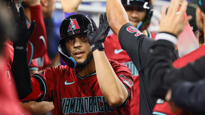 Aug 19, 2024; Miami, Florida, USA; Arizona Diamondbacks catcher Adrian Del Castillo (25) celebrates with teammates after hitting a grand slam against the Miami Marlins during the third inning at loanDepot Park.