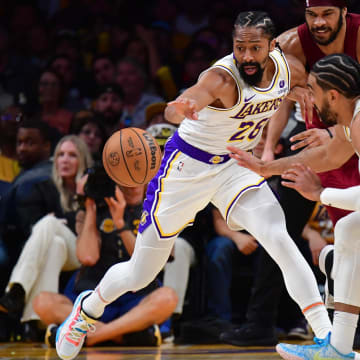 Apr 6, 2024; Los Angeles, California, USA; Los Angeles Lakers guard Spencer Dinwiddie (26) and guard Gabe Vincent (7) plays for the ball against Cleveland Cavaliers center Jarrett Allen (31) during the second half at Crypto.com Arena. Mandatory Credit: Gary A. Vasquez-USA TODAY Sports