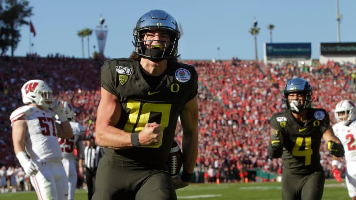 Oregon's Justin Herbert celebrates a first quarter touchdown against Wisconsin in the Rose Bowl in Pasadena on New Years Day 2020.