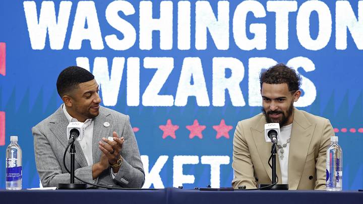 Jan 9, 2026; Washington, District of Columbia, USA; Washington Wizards general manager Will Dawkins (L) introduces newly acquired Wizards guard Trae Young (R) at a press conference prior to the Wizards' game against the New Orleans Pelicans at Capital One Arena. Mandatory Credit: Geoff Burke-Imagn Images