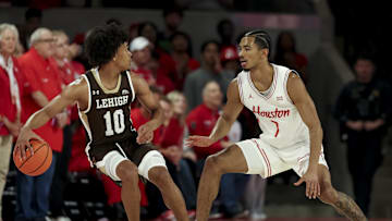 Nov 3, 2025; Houston, Texas, USA; Houston Cougars guard Milos Uzan (7) defends against Lehigh Mountain Hawks guard Caleb Thomas (10) during the first half at Fertitta Center. Mandatory Credit: Maria Lysaker-Imagn Images 