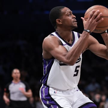 Apr 7, 2024; Brooklyn, New York, USA; Sacramento Kings guard De'Aaron Fox (5) shoots a three point basket during the first half against the Brooklyn Nets at Barclays Center. Mandatory Credit: Vincent Carchietta-Imagn Images