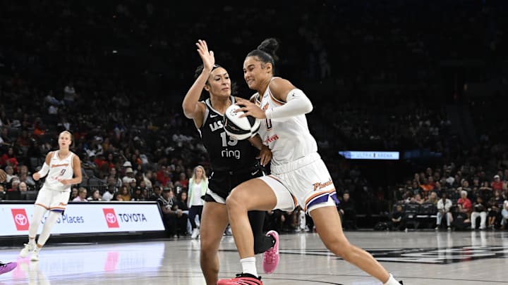 Jun 15, 2025; Las Vegas, Nevada, USA; Phoenix Mercury forward Satou Sabally (0) drives against Las Vegas Aces guard Aaliyah Nye (13) in the second quarter at Michelob Ultra Arena. Mandatory Credit: Candice Ward-Imagn Images