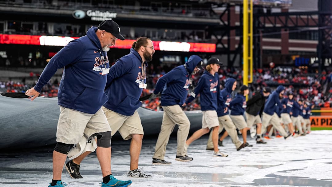 Detroit Tigers grounds crew remove the tarp from the field after the rain delay during ALDS Game 3 between Detroit Tigers and Seattle Mariners at Comerica Park in Detroit on Tuesday, Oct. 7, 2025. Detroit Tigers grounds crew remove the tarp from the field after the rain delay during ALDS Game 3 between Detroit Tigers and Seattle Mariners at Comerica Park in Detroit on Tuesday, Oct. 7, 2025.