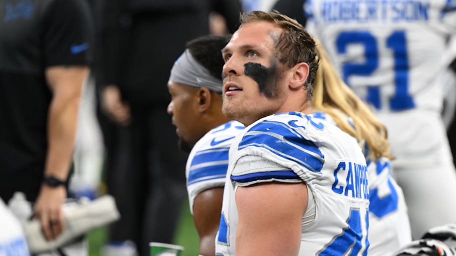 Jack Campbell looks up from the Lions’ bench with no helmet on.