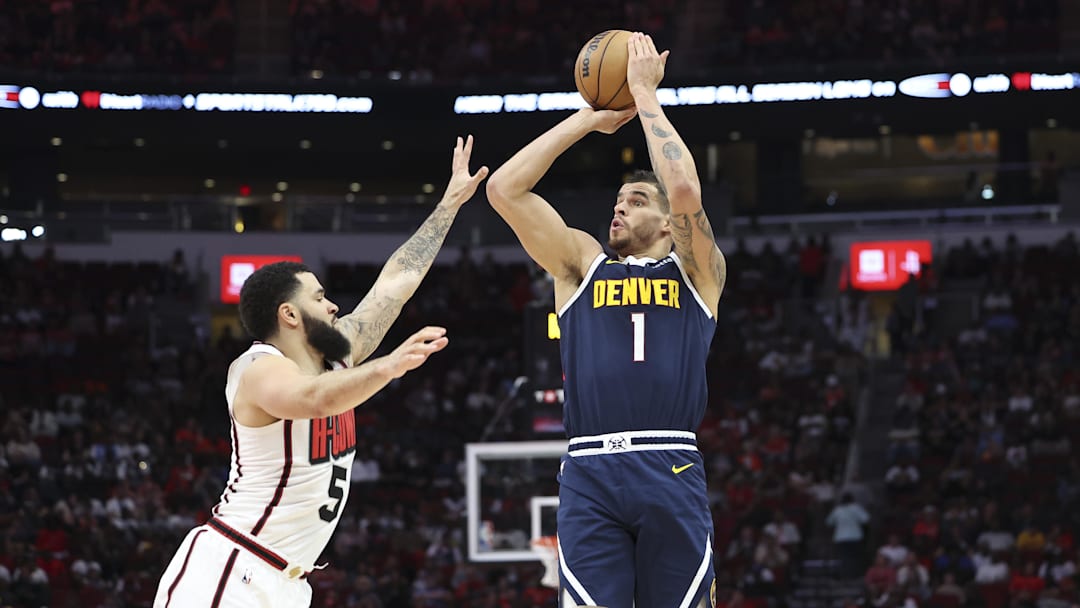 Mar 23, 2025; Houston, Texas, USA; Denver Nuggets forward Michael Porter Jr. (1) shoots the ball as Houston Rockets guard Fred VanVleet (5) defends during the third quarter at Toyota Center. Mandatory Credit: Troy Taormina-Imagn Images