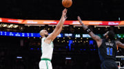 Jun 6, 2024; Boston, Massachusetts, USA; Boston Celtics guard Derrick White (9) shoots against Dallas Mavericks guard Kyrie Irving (11) in the third quarter during game one of the 2024 NBA Finals at TD Garden. Mandatory Credit: David Butler II-USA TODAY Sports