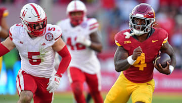 Nov 16, 2024; Los Angeles, California, USA; Southern California Trojans running back Woody Marks (4) runs the ball ahead of Nebraska Cornhuskers linebacker John Bullock (5) during the second half at the Los Angeles Memorial Coliseum. Mandatory Credit: Gary A. Vasquez-Imagn Images
